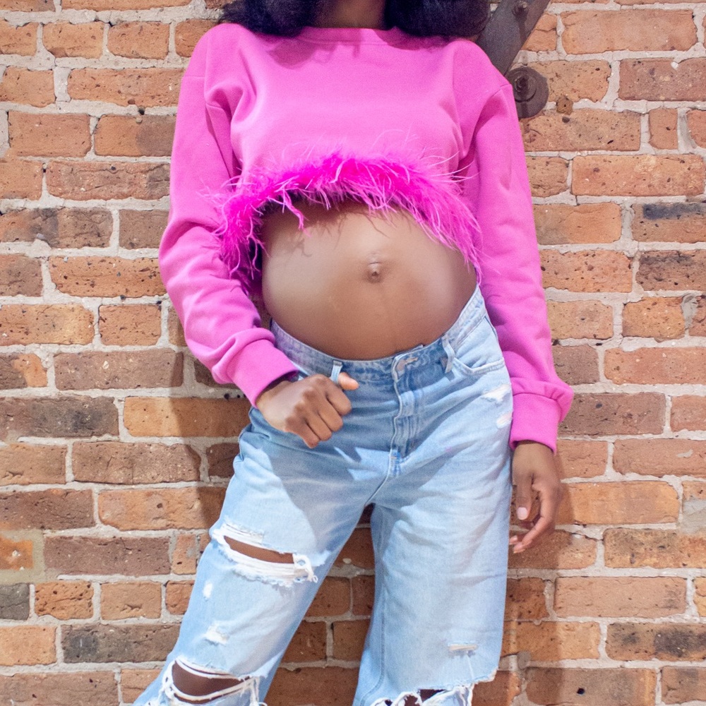 MIMI" sweater is long sleeves with faux feather trim.